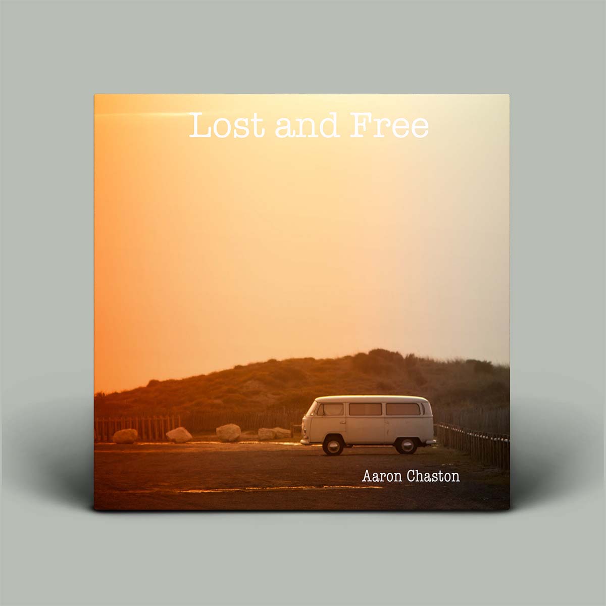 Album cover titled 'Lost and Free' by Aaron Chaston with a van and sunset landscape.