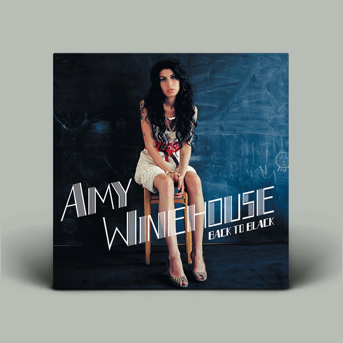 Amy Winehouse 'Back to Black' album cover displayed as a physical square vinyl record sleeve against a neutral gray background.