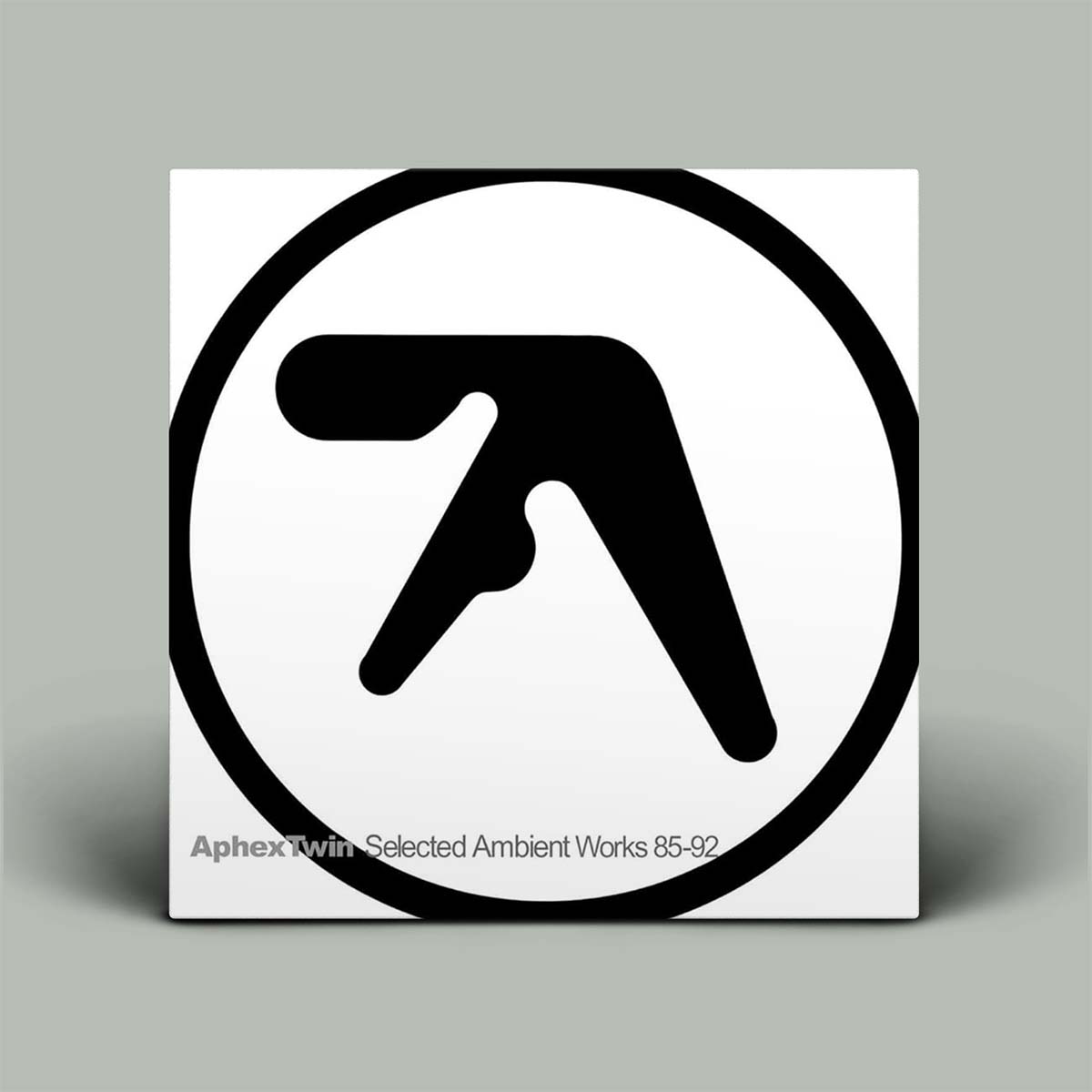 Album cover with a black and white logo on a gray background
