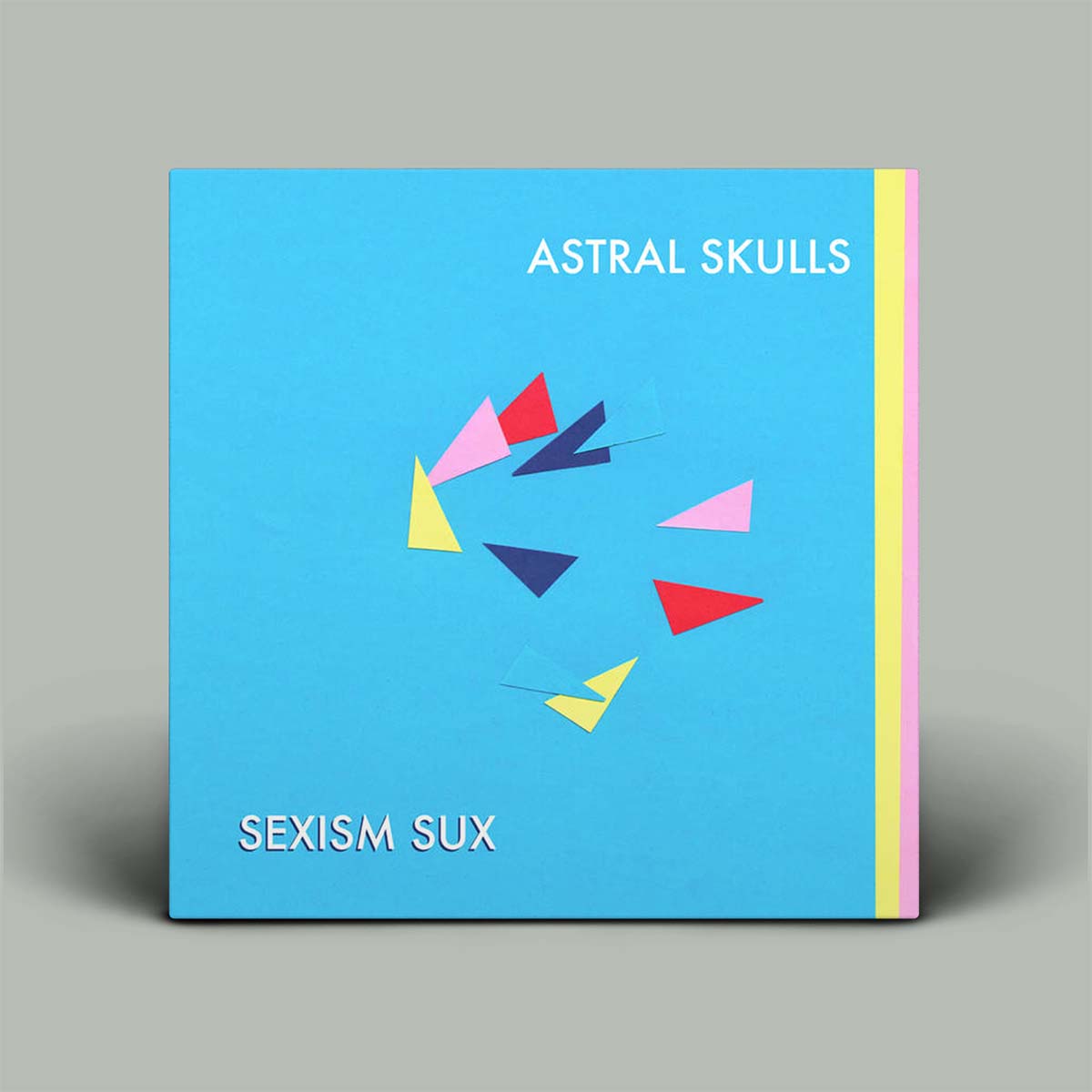 Blue album cover with colorful geometric design and text 'Astral Skulls' and 'Sexism Sux' on a gray background