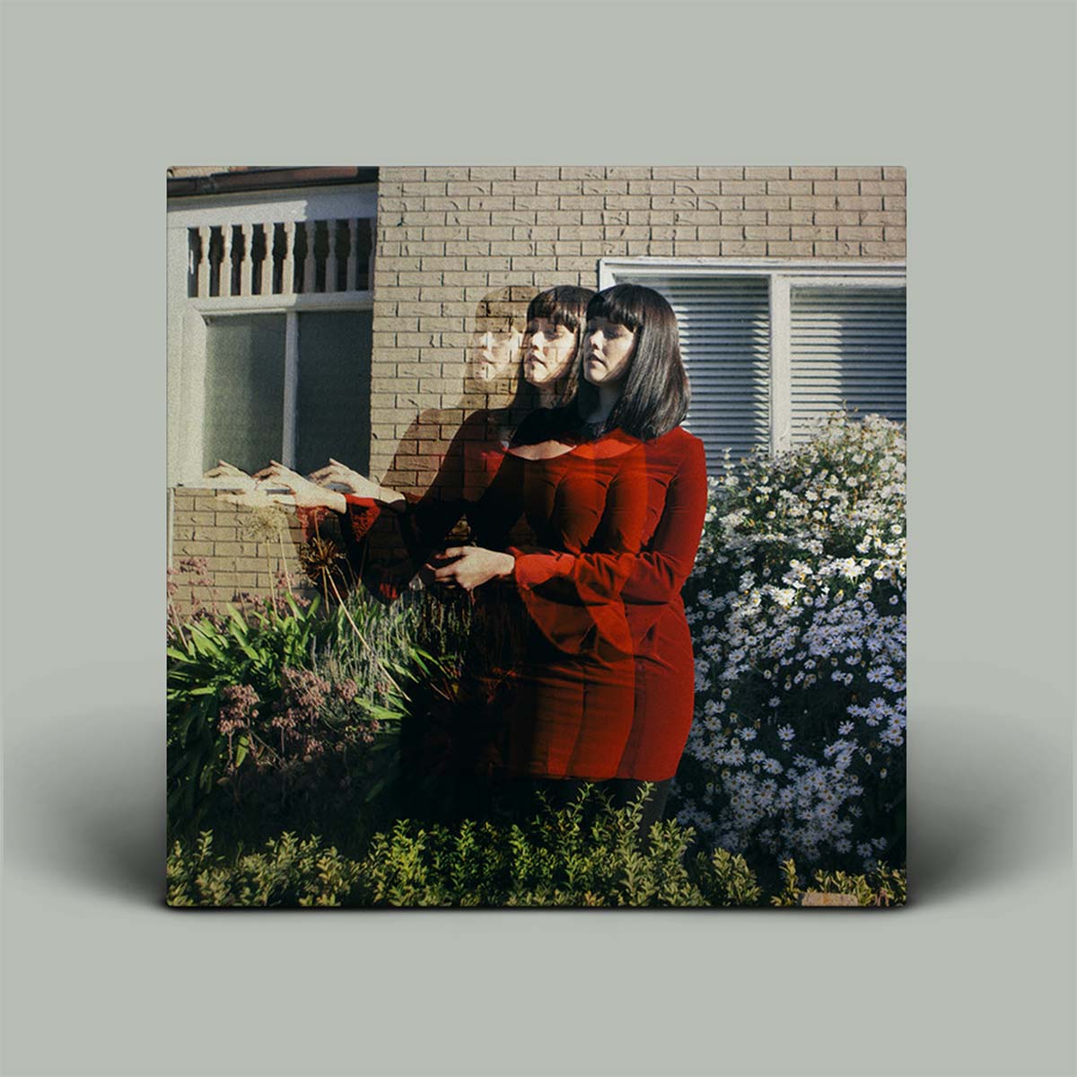 Album cover with photograph of female in garden.