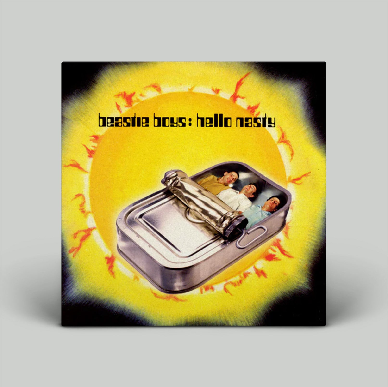 Album cover for 'Beastie Boys: Hello Nasty' with a yellow background and metallic object.
