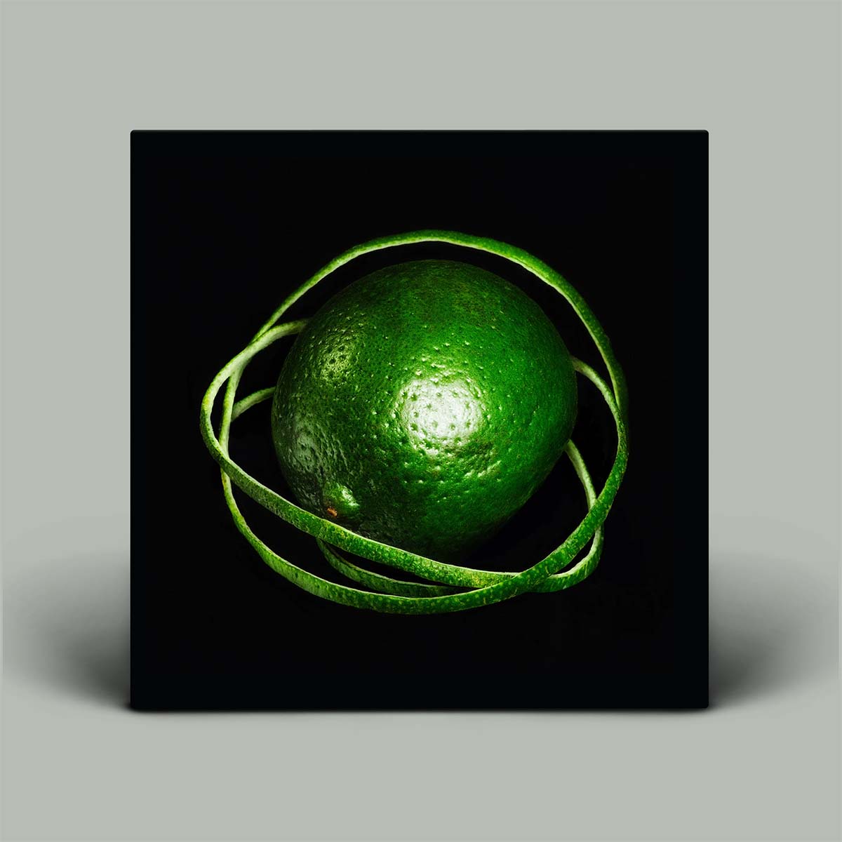 Album cover featuring an image of a green lime with peel on a black background.