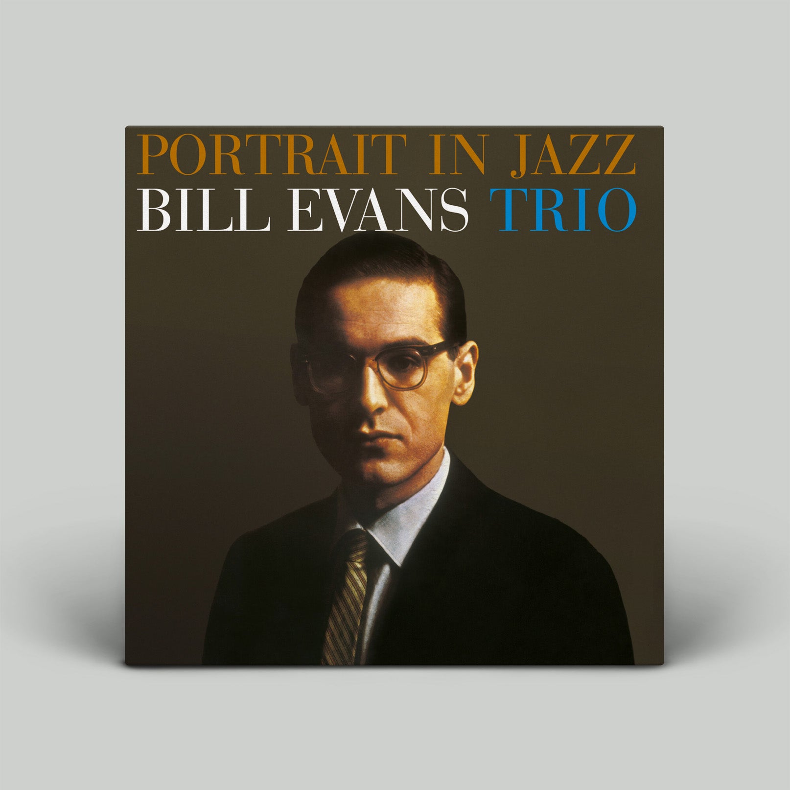 Album cover of 'Portrait in Jazz' by Bill Evans Trio with a portrait of Bill Evans on a gray background.