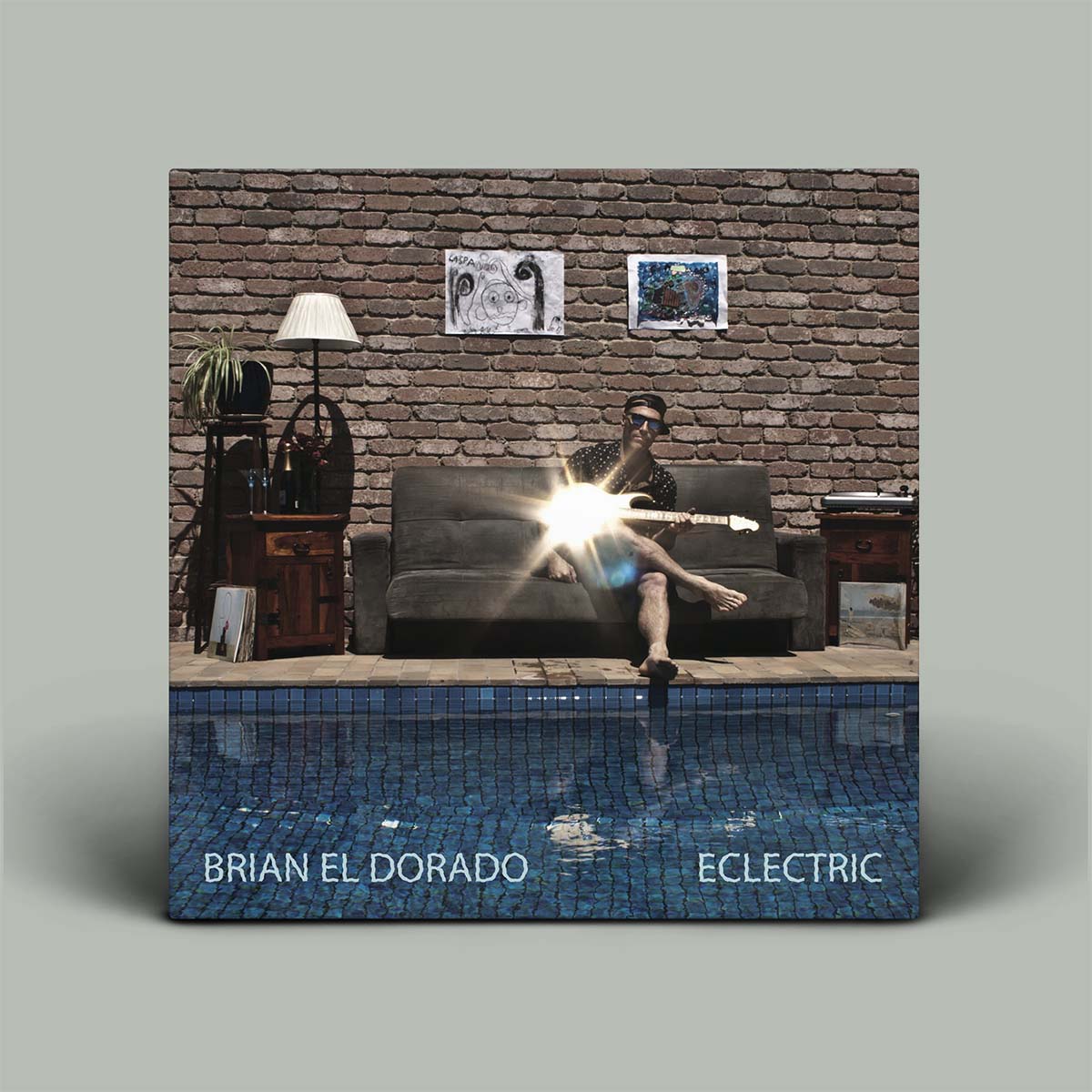 Album cover with a person on a couch by a pool, featuring 'Brian El Dorado' and 'Eclectric'.