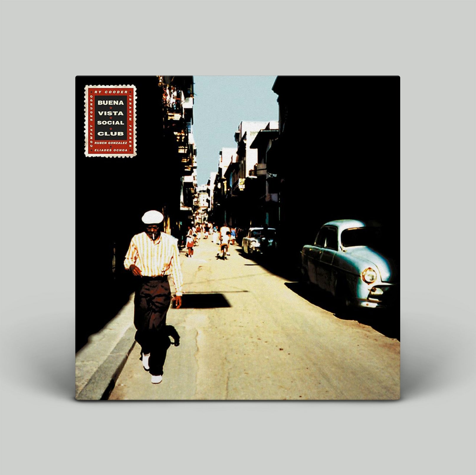 Vinyl record cover with a street scene and person walking, featuring 'Buena Vista Social Club' album art.