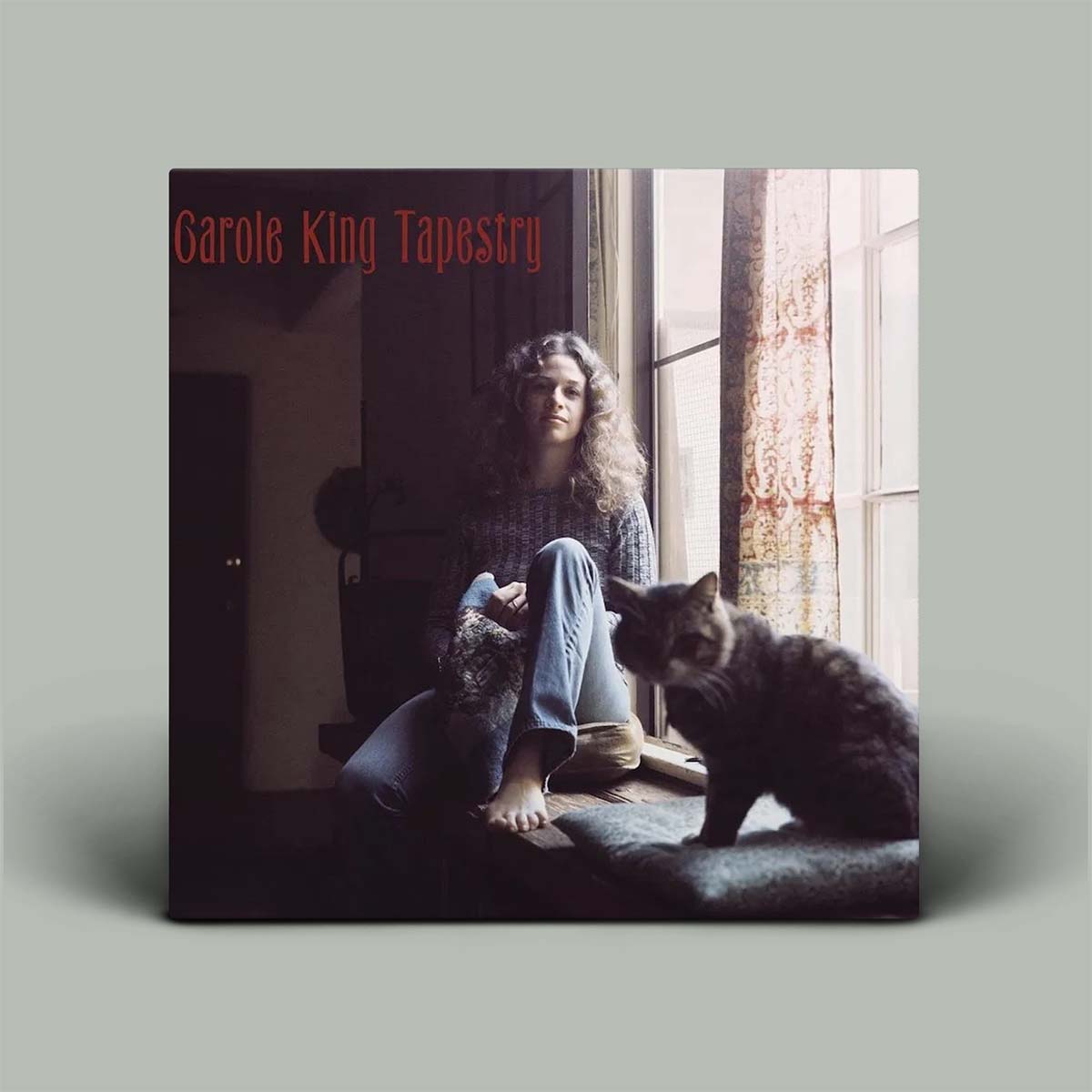 Album cover featuring a person with cats sitting by a window, titled 'Garole King Tapestry'.