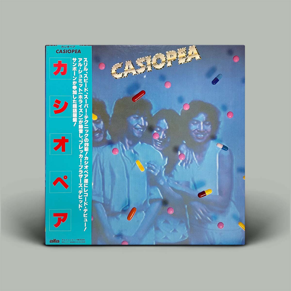 Album cover for Casiopea with stylized text and graphics on a blue background