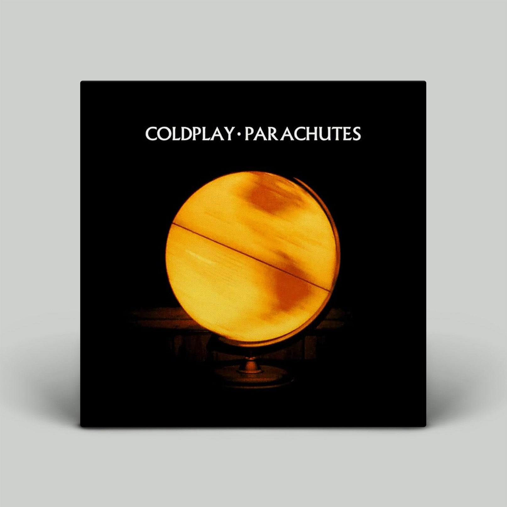 Album cover for Coldplay's 'Parachutes' with a glowing sphere design on a black background.