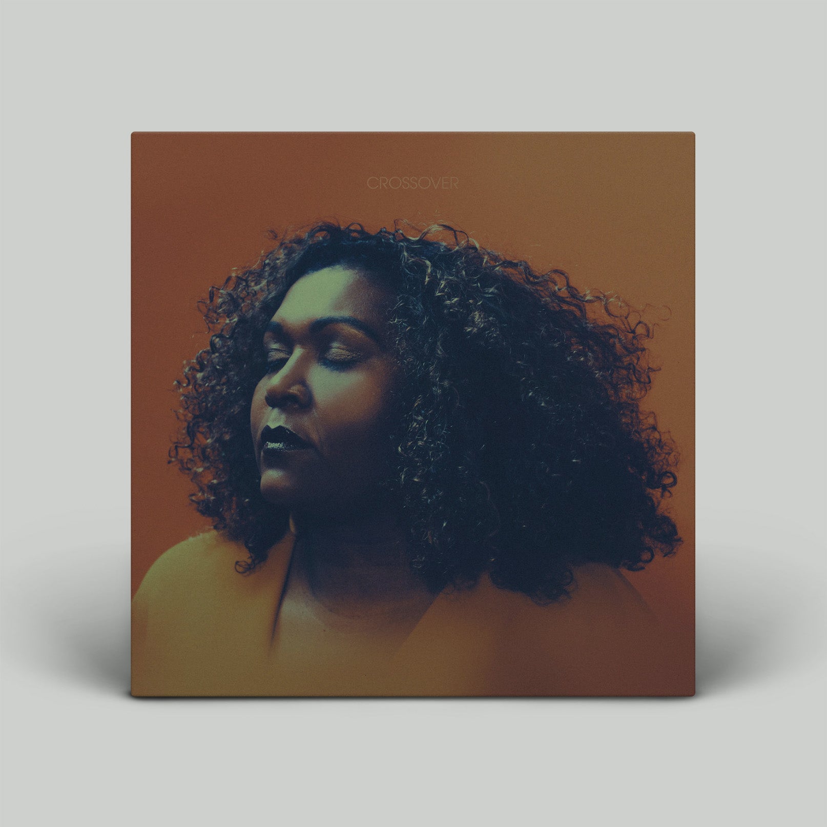 Album cover with a person with curly hair on a brown background