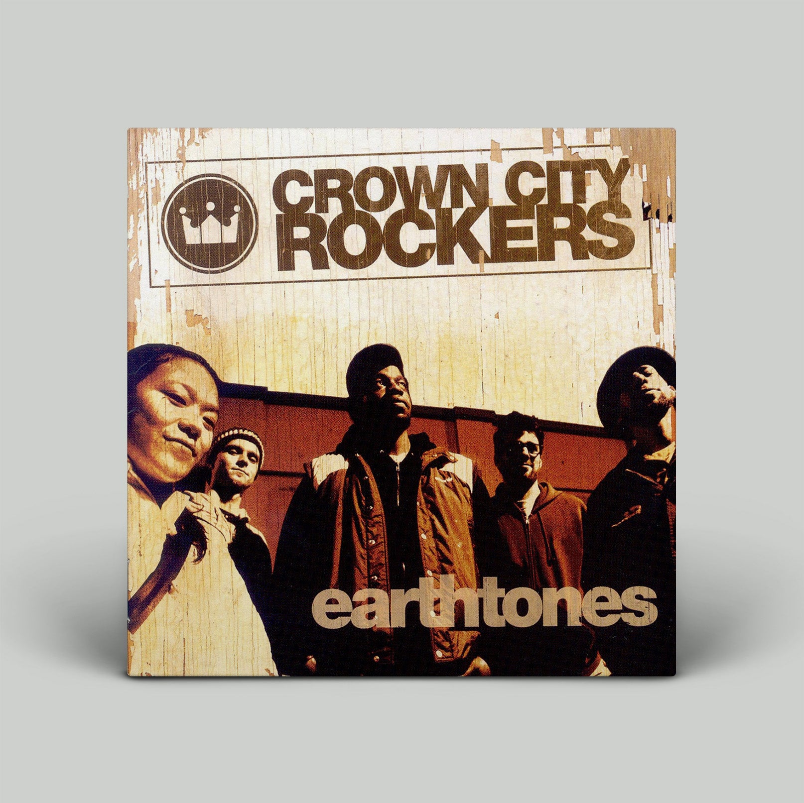 Album cover for 'Crown City Rockers' with four individuals and 'earthtones' text on a wooden background.