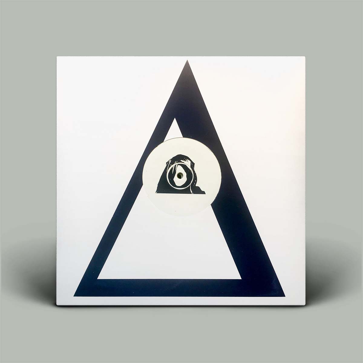 Album cover with a triangle design and central circular emblem on a gray background