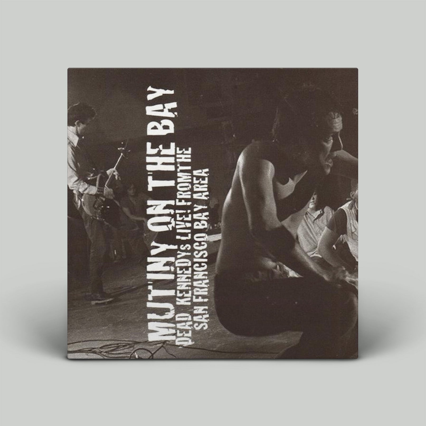 Album cover with text 'Mutiny on the Bay' and black and white photo of people around a table.