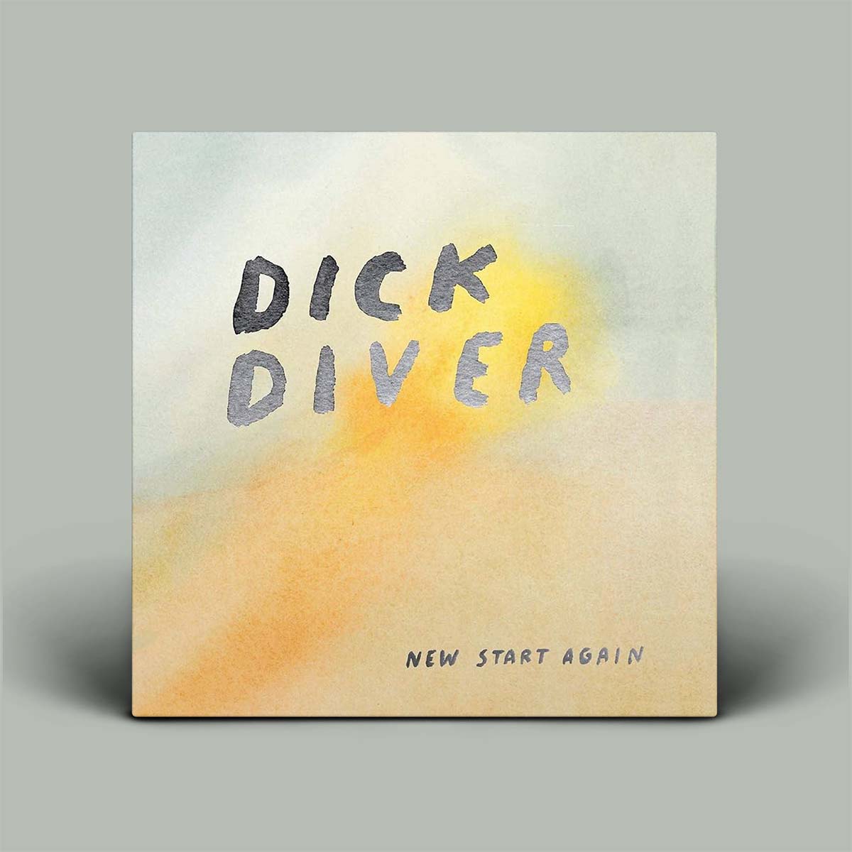 A square album cover for 'New Start Again' by Dick Diver, featuring a watercolor-style background with soft yellow, orange, and pale blue washes, and the text 'DICK DIVER' and 'NEW START AGAIN' in a simple hand-drawn font, shown against a neutral gray background.