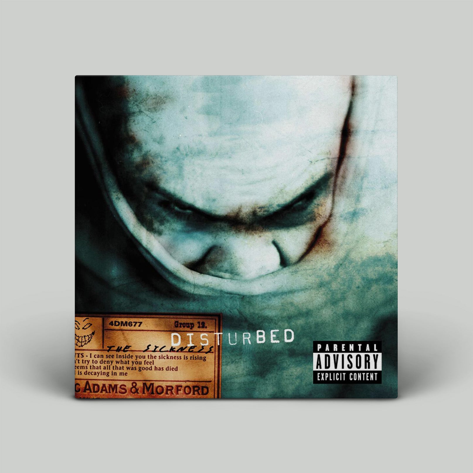 Album cover for Disturbed with a close-up of a face and text on a gray background