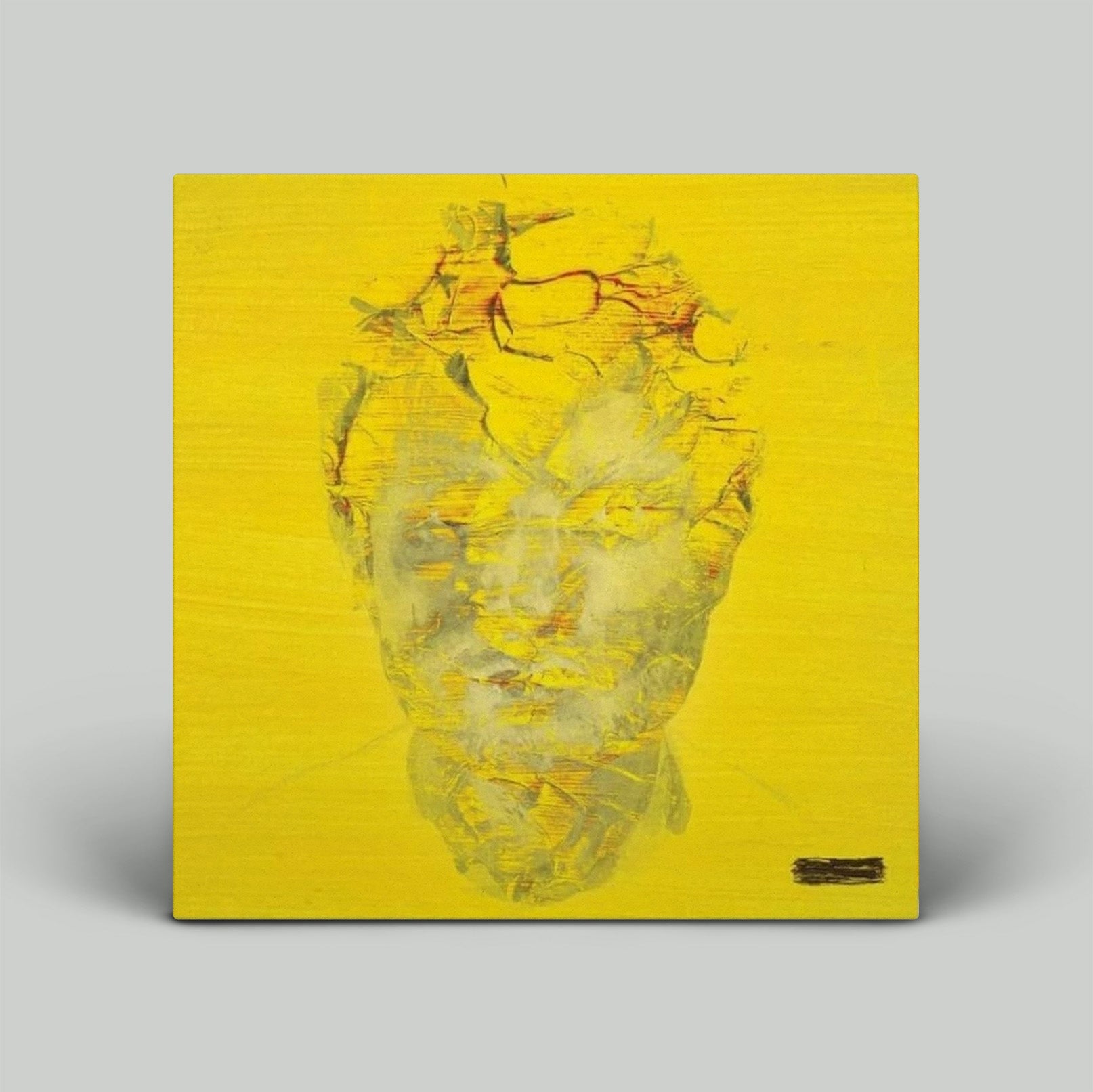 Yellow album cover with artistic design on a gray background