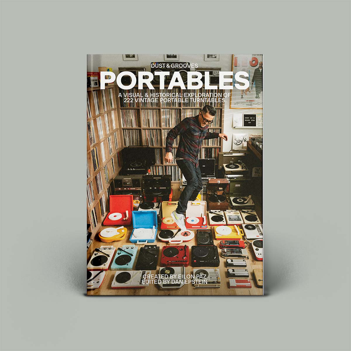 Photograph of man stepping over a floor of portable turntables.