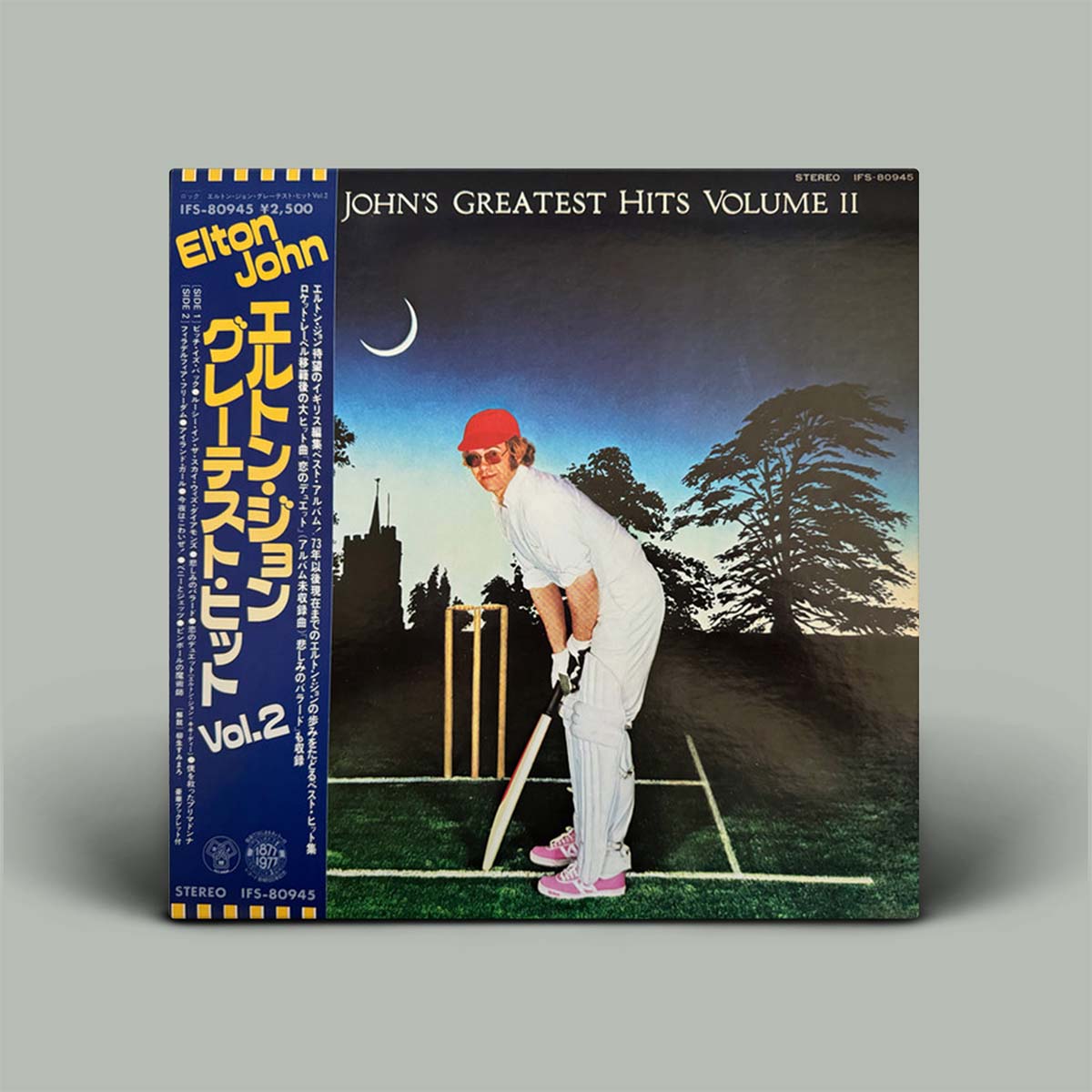 Vinyl album cover with a person playing cricket and text on a gray background