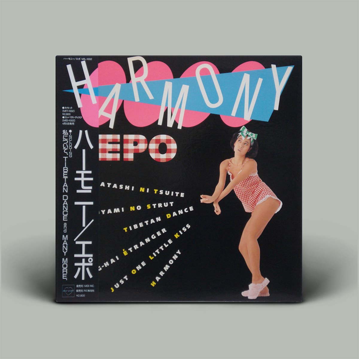 Vinyl record cover with a stylized illustration of a woman and the word 'Harmony' on a black background.