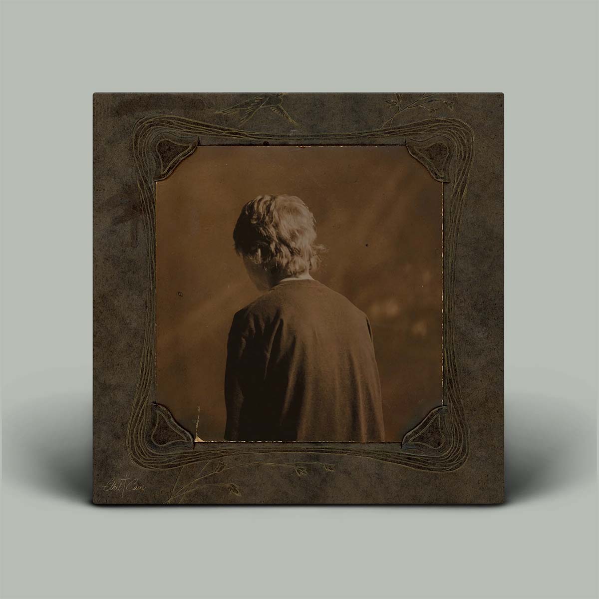 Vintage-style portrait of a person with a decorative frame on a plain background