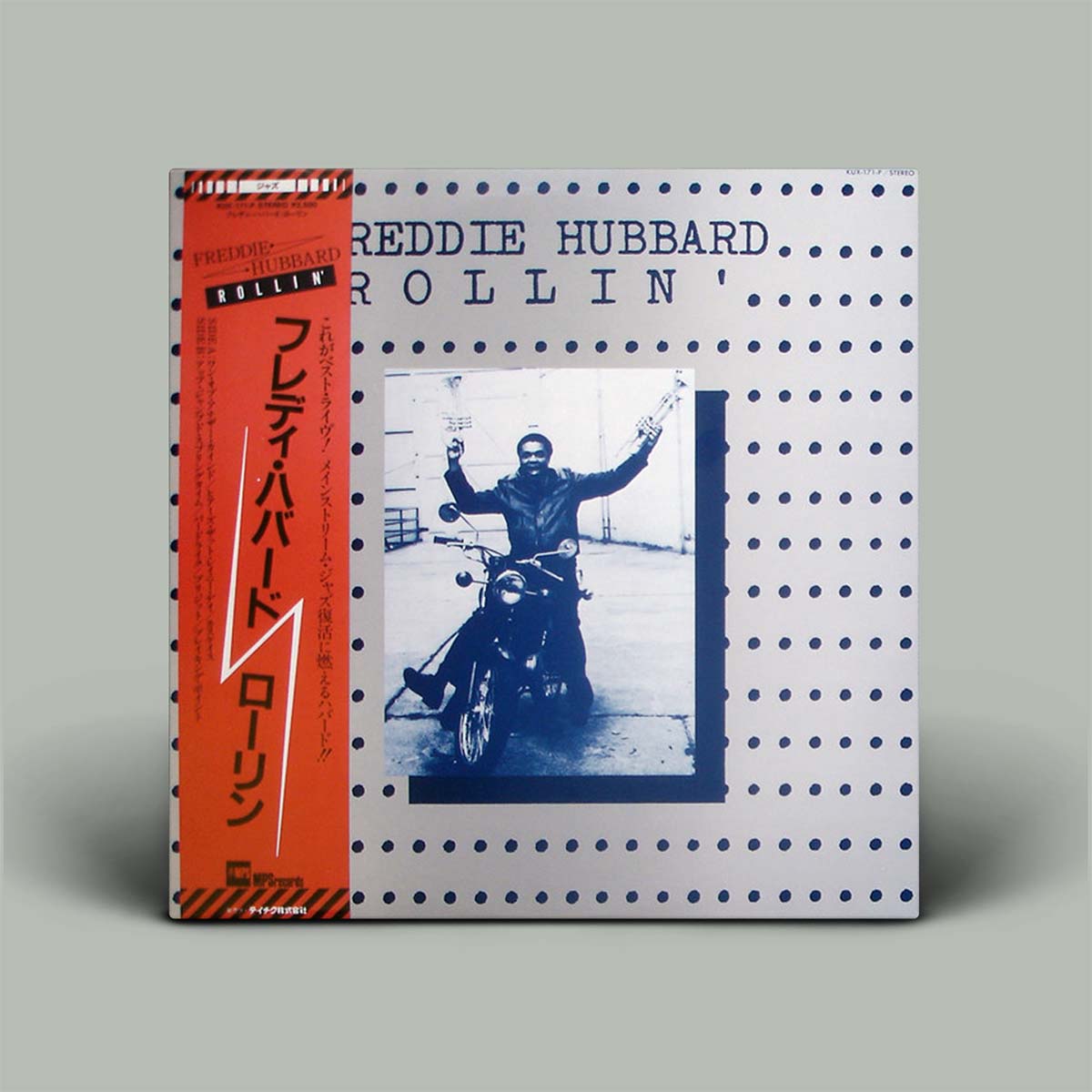 Album cover with a motorcycle rider on a gray background