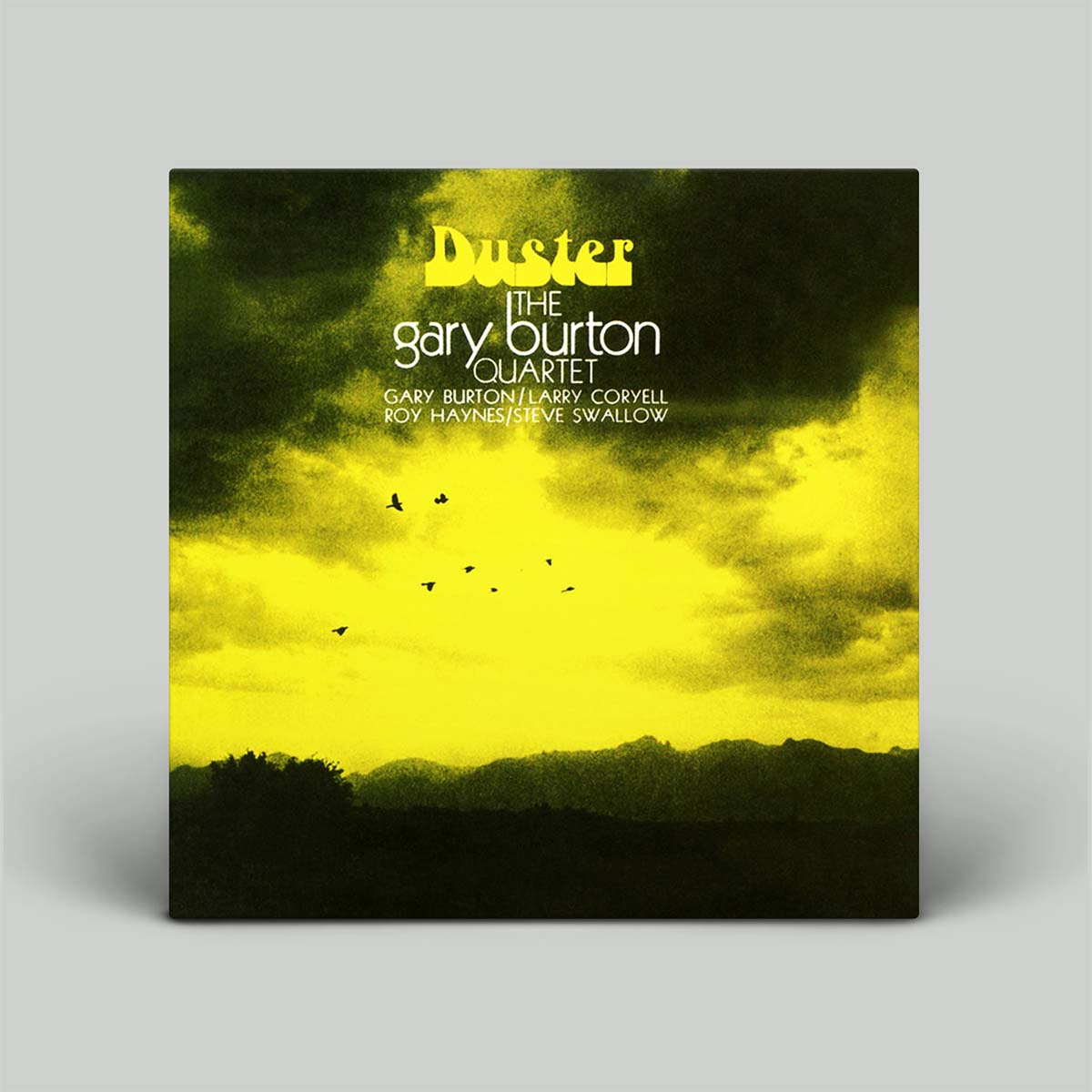 A square album cover for 'Duster' by The Gary Burton Quartet, featuring a dramatic yellow and black sky over a dark mountain range, shown against a light gray background.