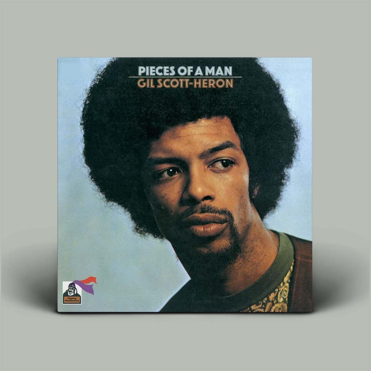 Gil Scott-Heron's 'Pieces of a Man' vinyl record album cover, shown as a square album sleeve standing upright against a neutral gray background.