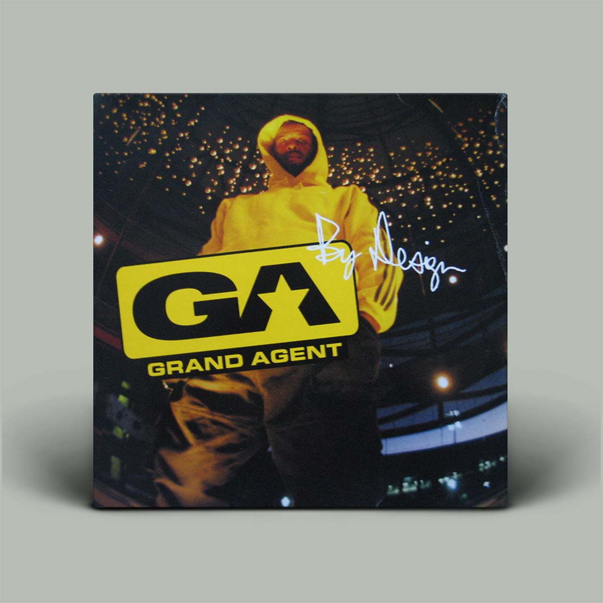 Product packaging with a person in a yellow hoodie and 'Grand Agent' logo.