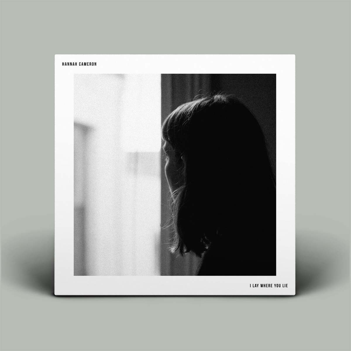 Album cover with silhouette of a person and text on a gray background