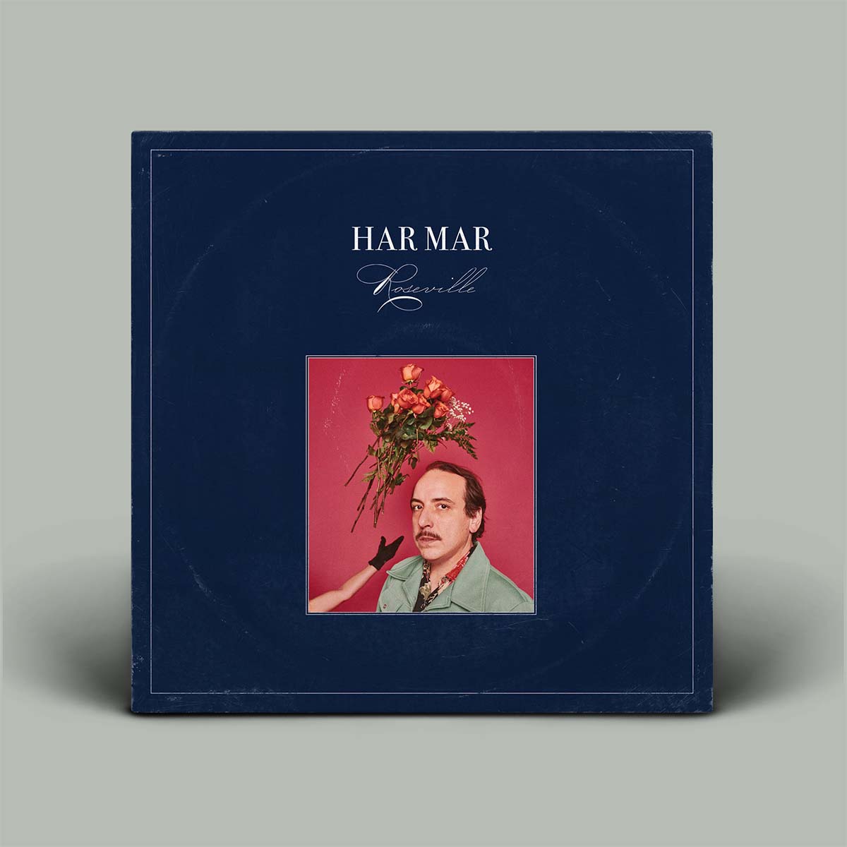 Album cover with a portrait and flowers on a blue background