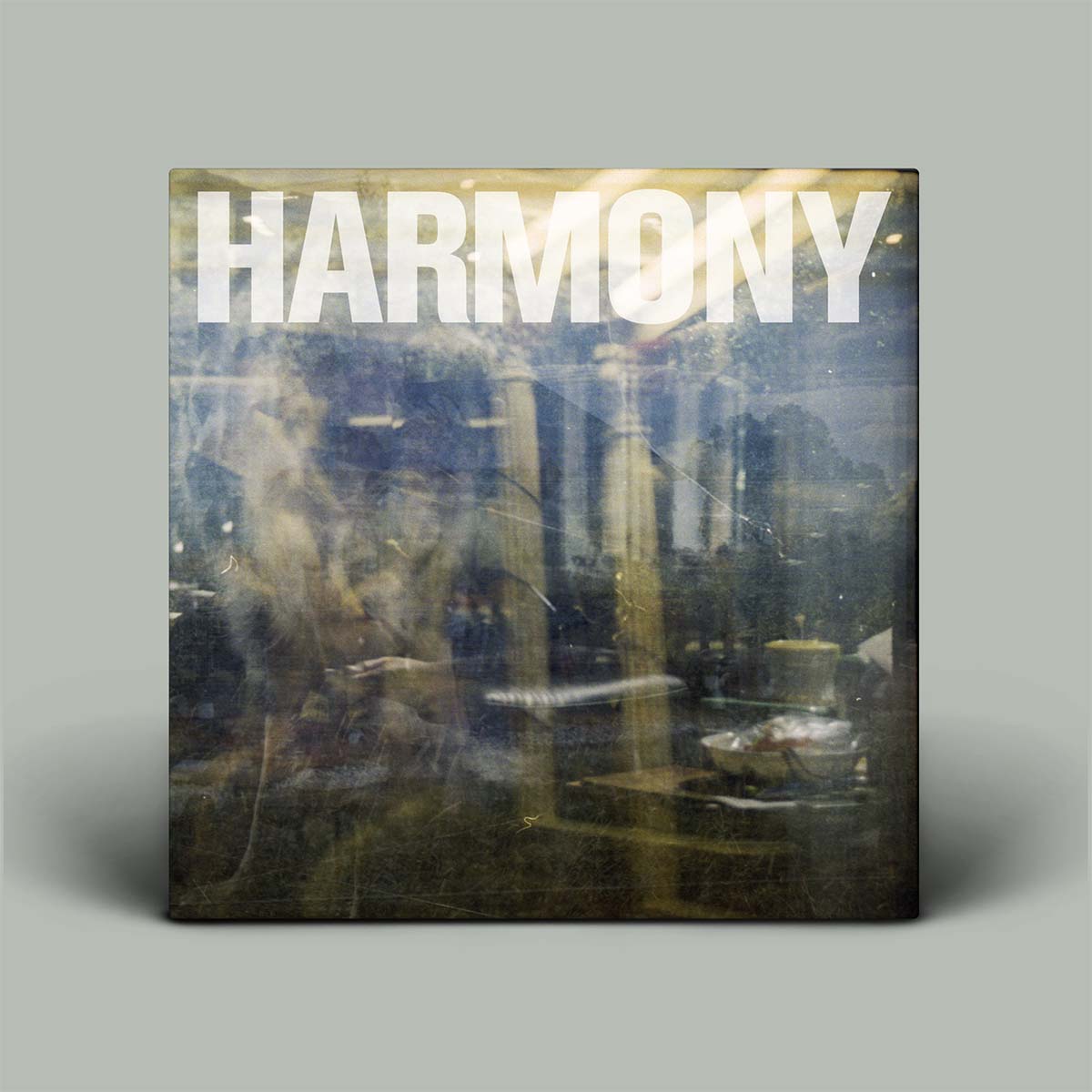 Album cover with 'HARMONY' text on a reflective surface
