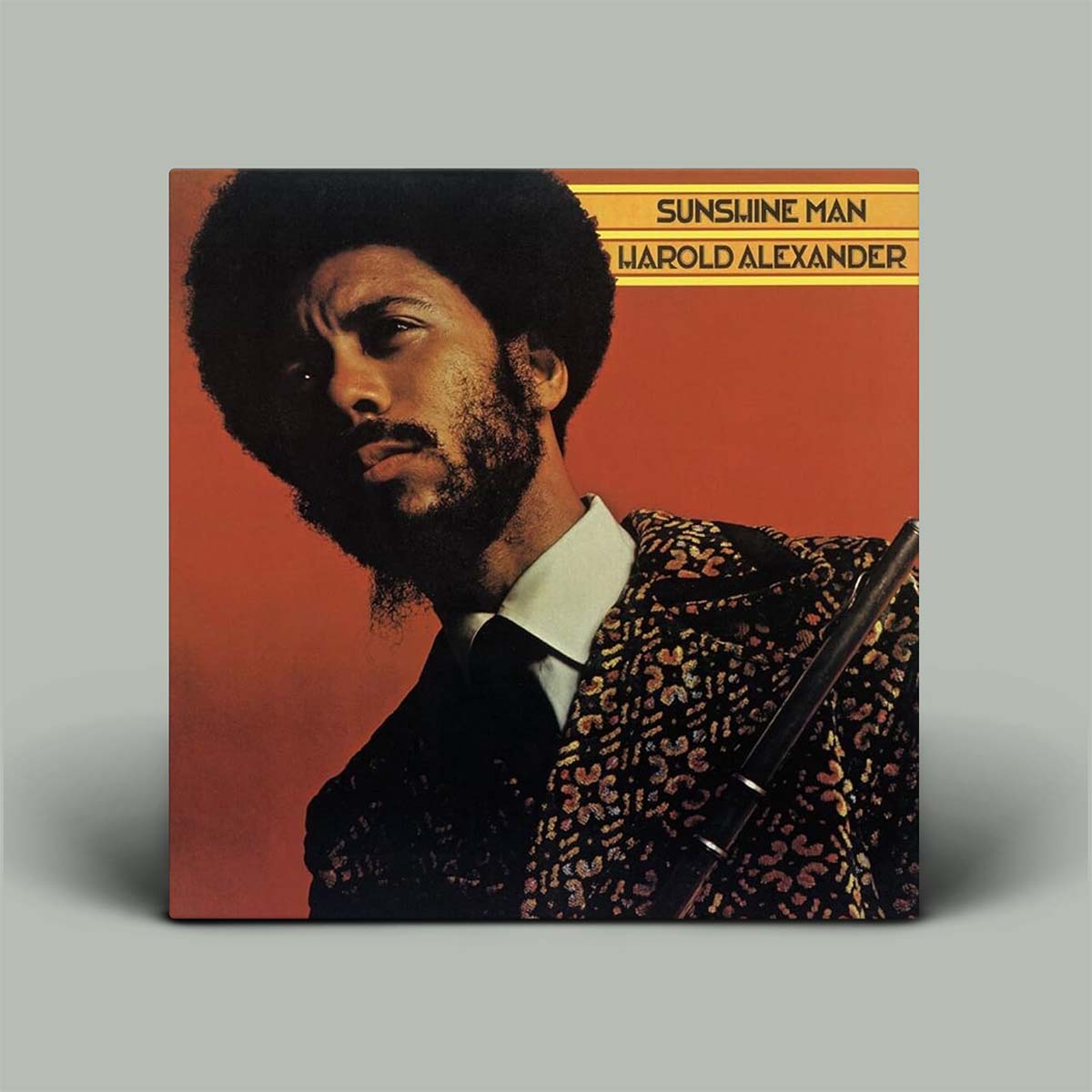 Album cover of 'Sunshine Man' by Harold Alexander with a portrait of a man on a red background.
