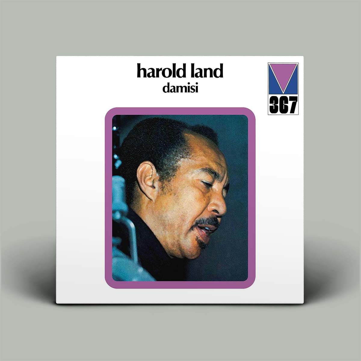 Album cover with a portrait of a man and text on a gray background