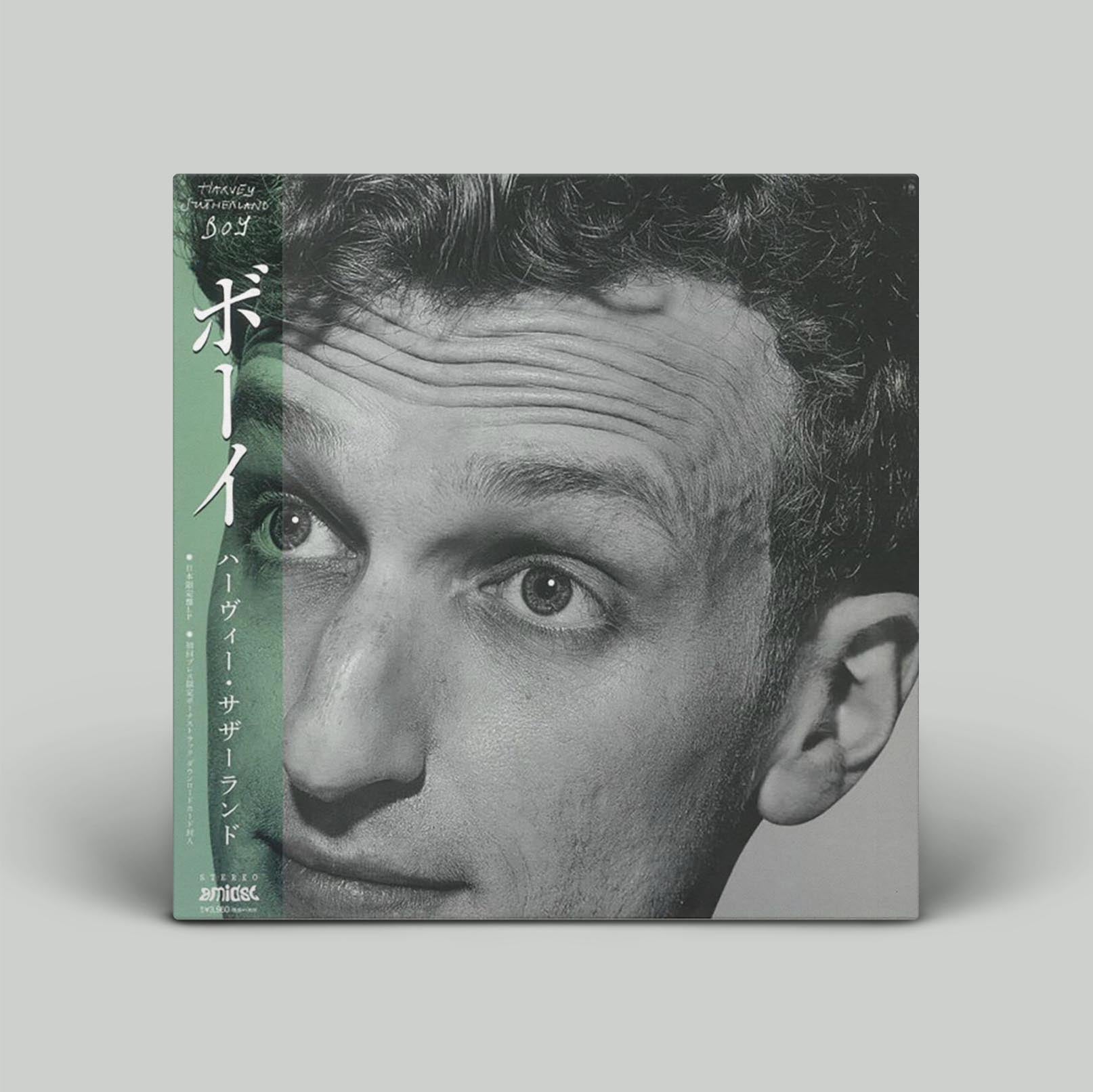 Black and white album cover featuring a portrait of a man, with text that includes the title 'Boy' and additional information related to the album.