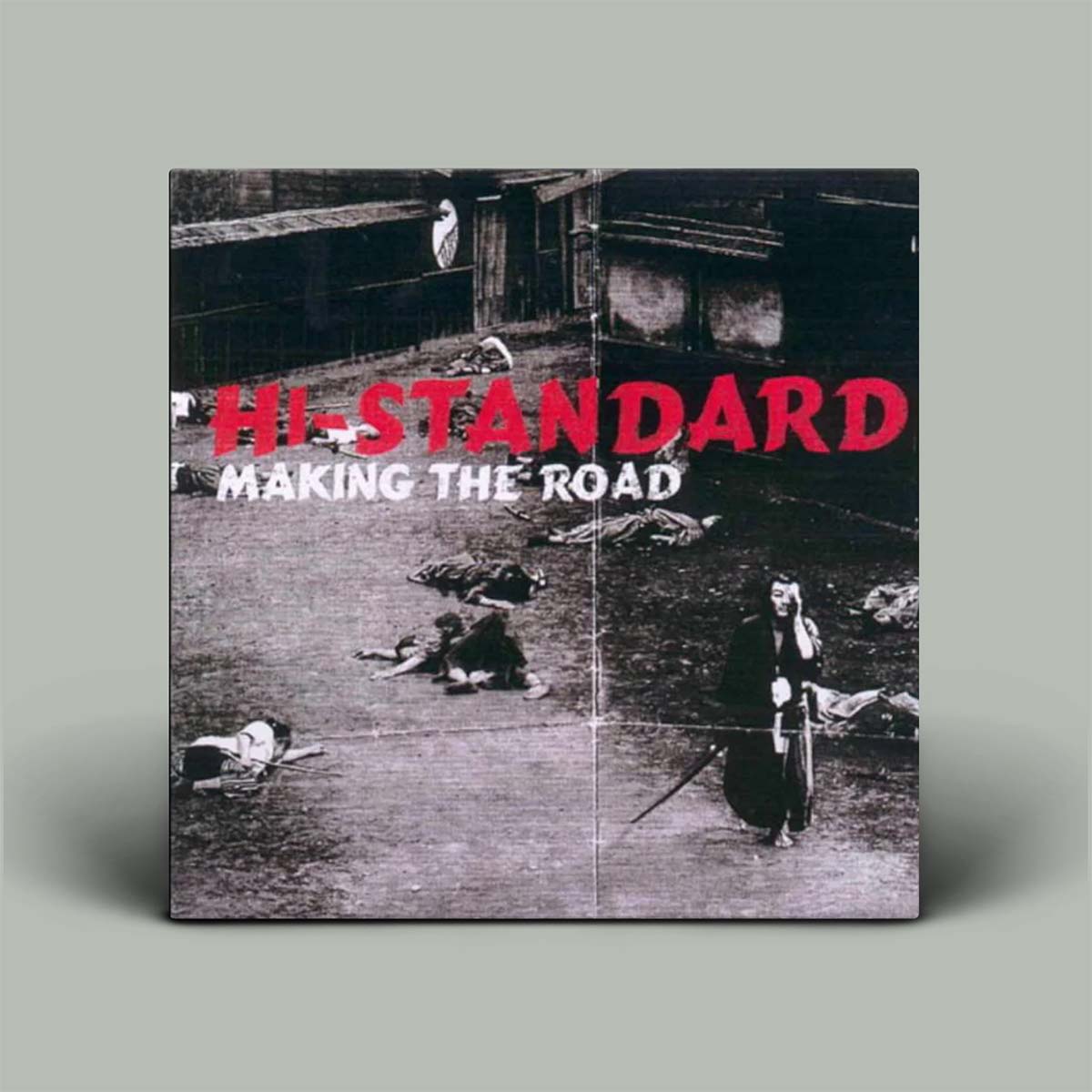Album cover for 'HI-STANDARD Making the Road' with black and white photo and red text.