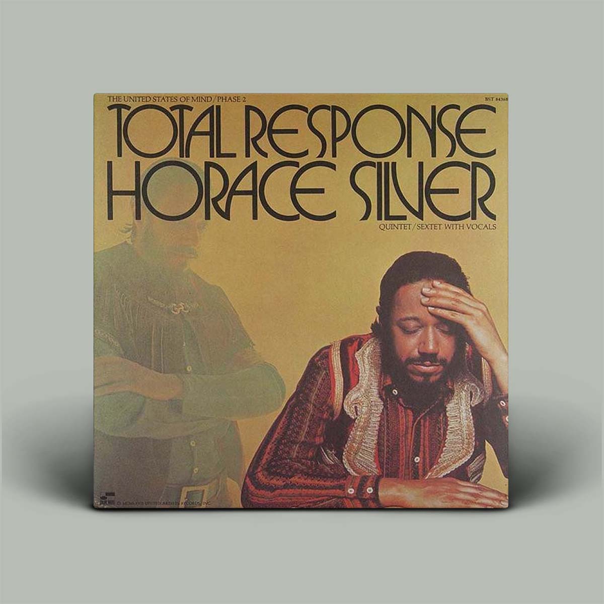 Horace Silver's 'Total Response' vinyl record album cover, featuring a sepia-toned background with black stylized text and two illustrated figures, shown standing against a neutral gray background.