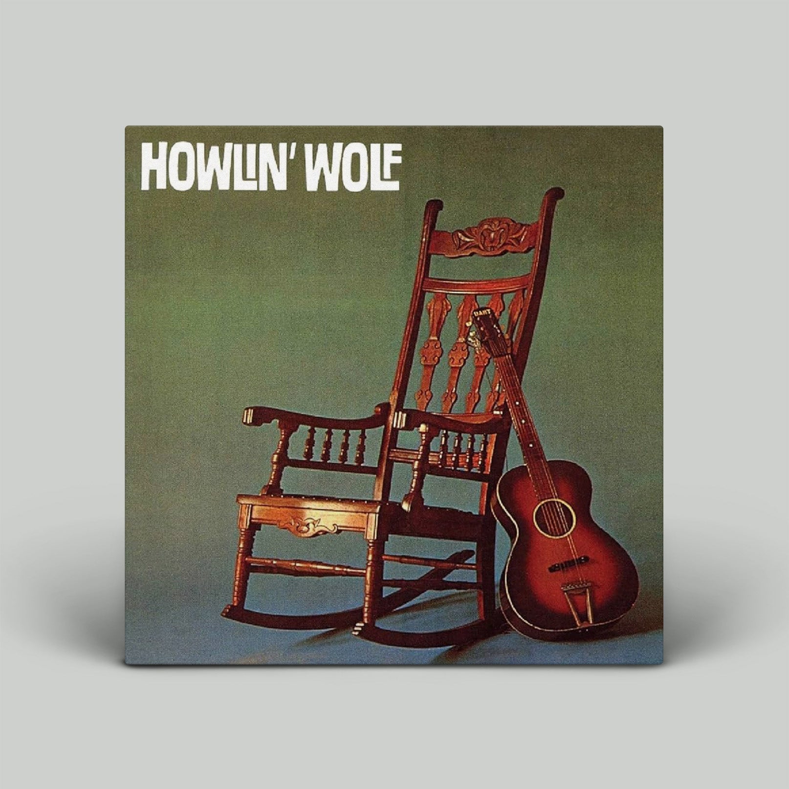 Album cover with a wooden rocking chair and guitar on a gradient background, featuring the text 'Howlin' Wolf'.