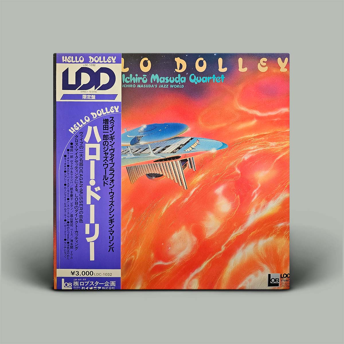 Vinyl record cover with colorful design and text on a gray background
