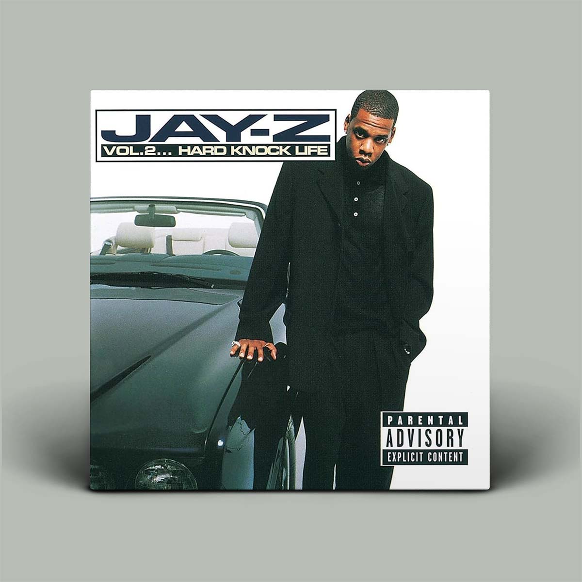 Album cover with photo of man beside car.