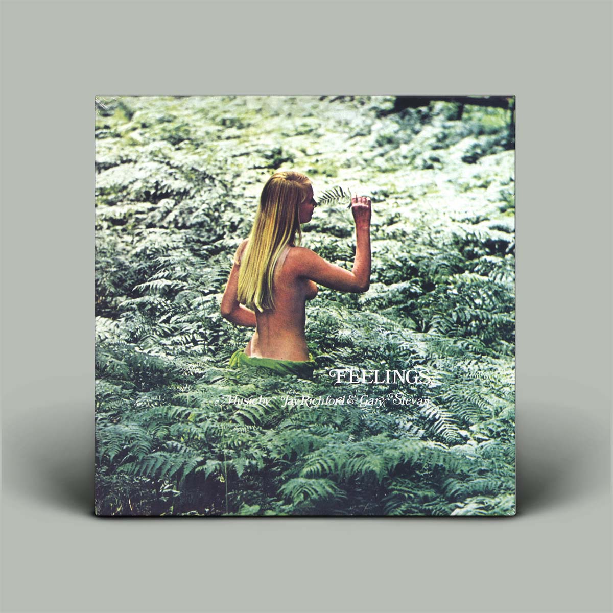 Album cover with a person in a forest and 'FEELINGS' title.