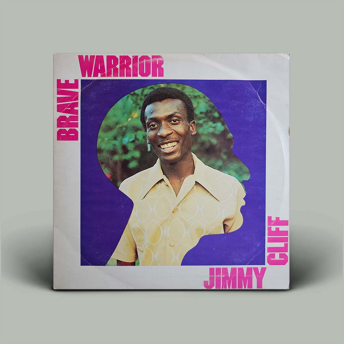 Vinyl record cover with a person's portrait and text 'Warrior Brave Jimmy Cliff' on a gray background