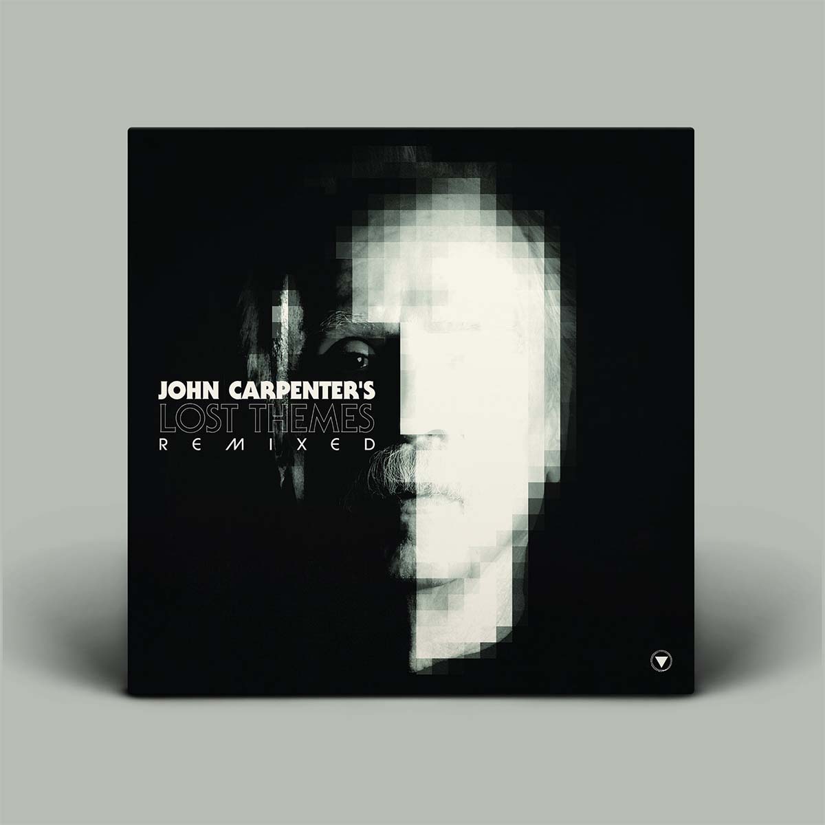 Album cover for 'John Carpenter's Lost Themes Remixed' with a black and white face design on a gray background.