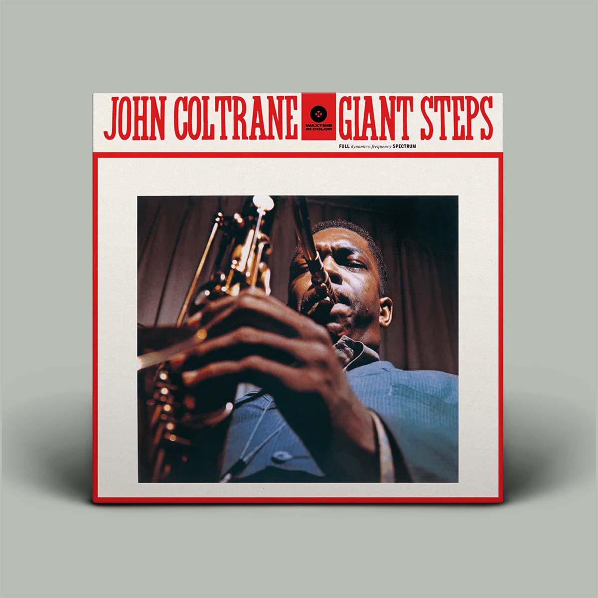 John Coltrane 'Giant Steps' album cover shown as a square product mockup on a light gray background. The cover features red title text at the top, a central photograph of Coltrane playing a saxophone, and a red border.