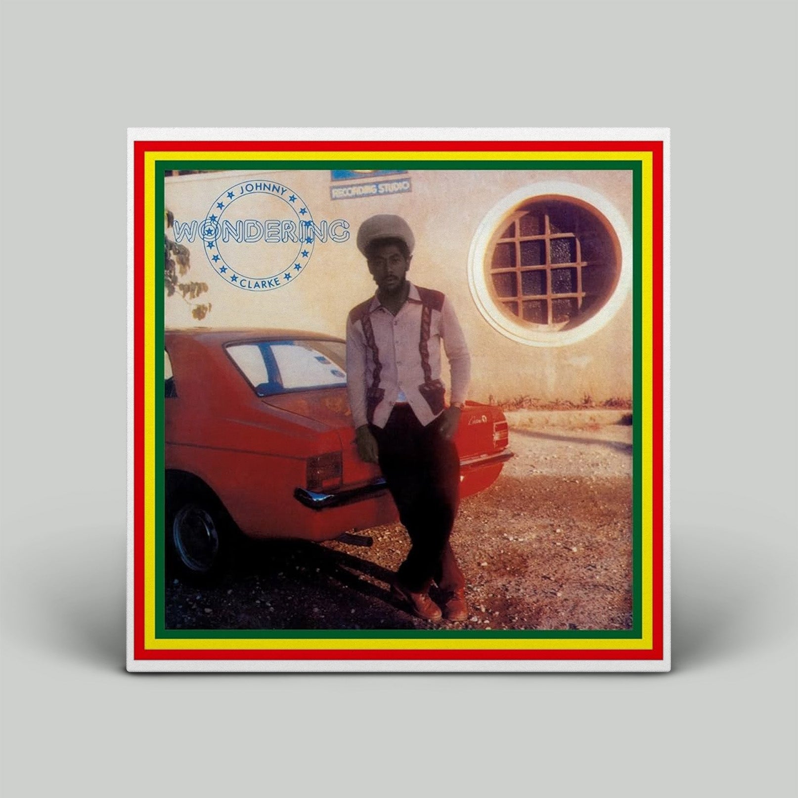 Album cover with a person standing next to a red car, featuring a colorful border.
