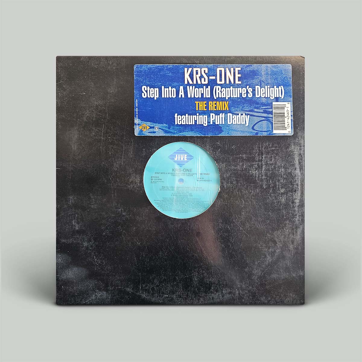 A vinyl record sleeve for KRS-One's 'Step Into A World (Rapture's Delight) The Remix' featuring Puff Daddy, with a dark textured cover and a light blue circular record visible through a cutout, on a light gray background.