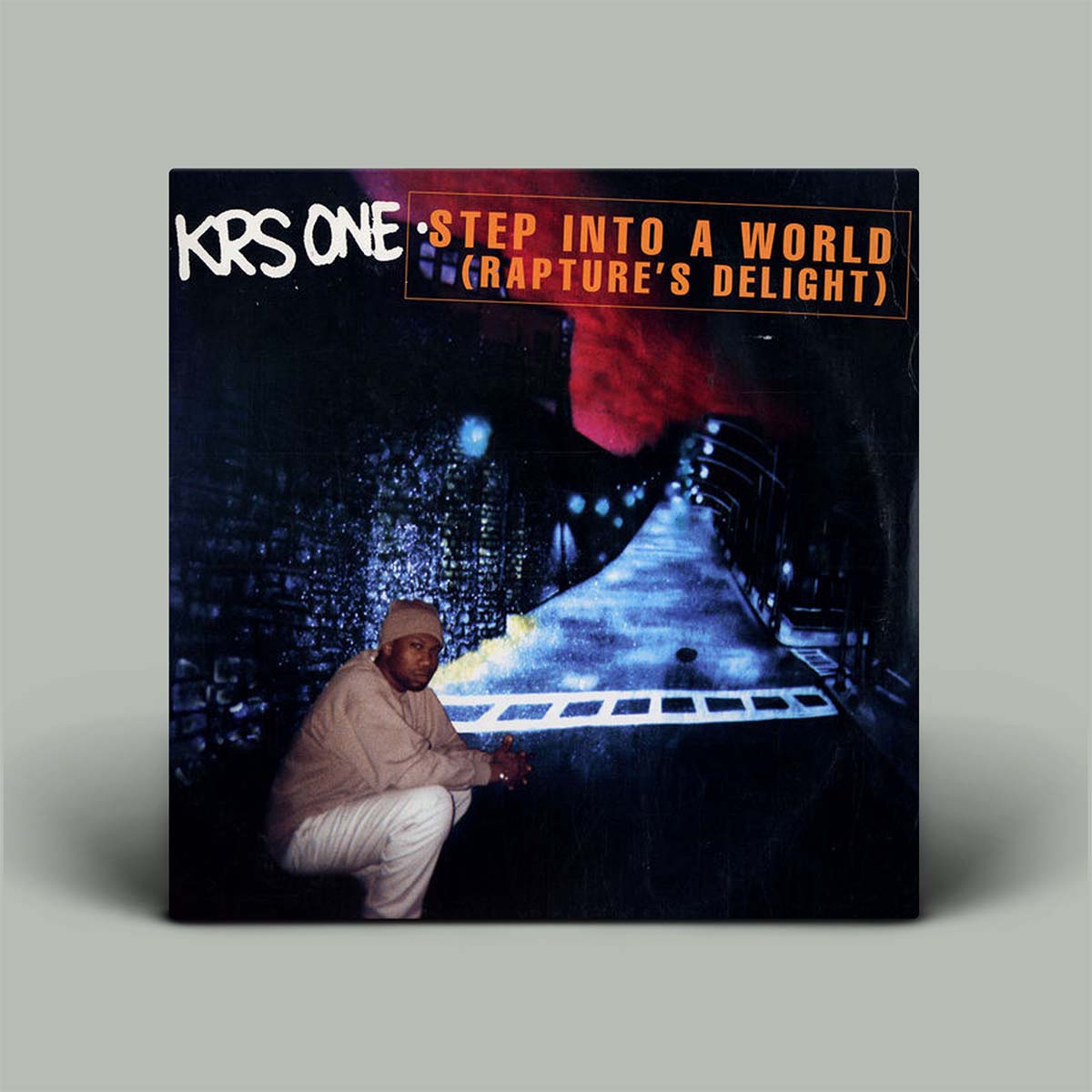 KRS-One's 'Step Into A World (Rapture's Delight)' vinyl record album cover, displayed on a neutral gray background with a drop shadow.