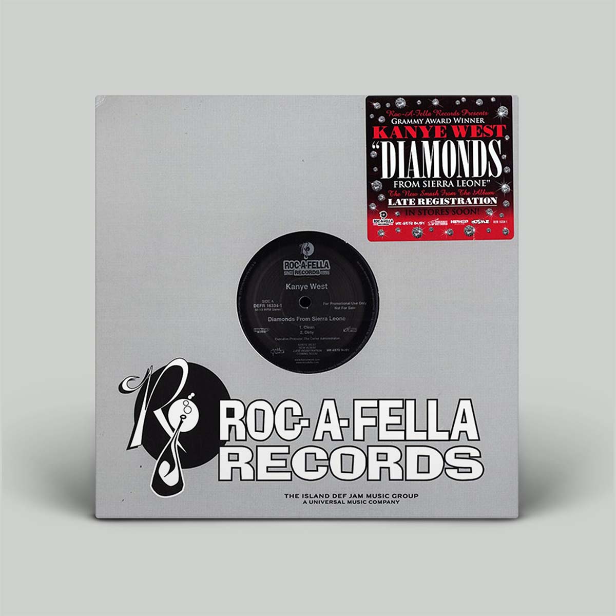A vinyl record sleeve for Kanye West's 'Diamonds From Sierra Leone' on Roc-A-Fella Records, shown on a light gray background. The sleeve is light gray with a black center label and features a red and black late-registration sticker in the top right corner.