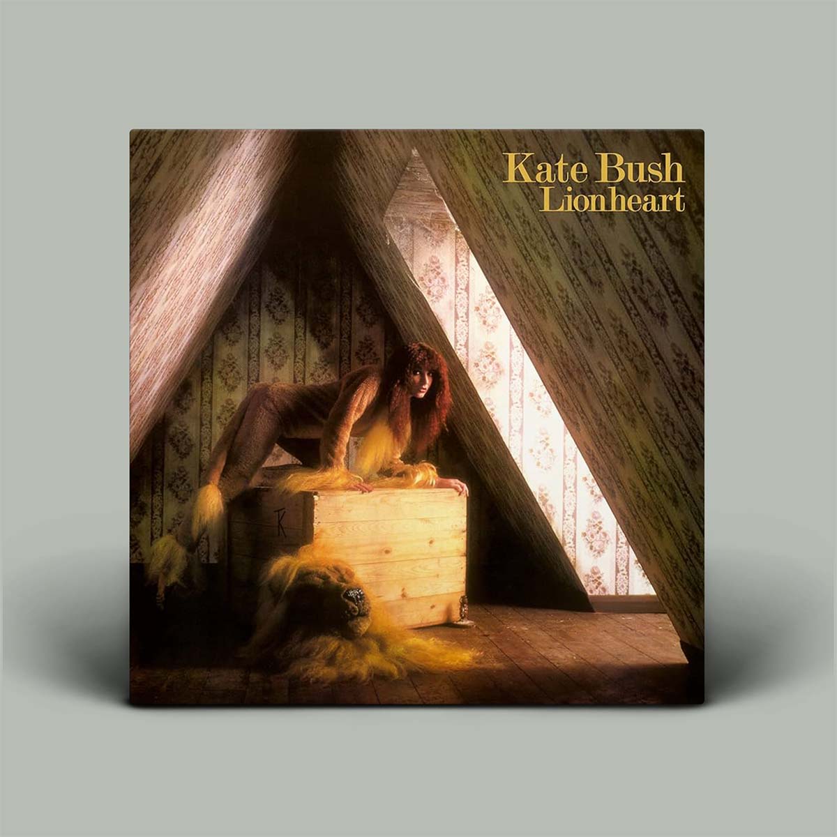 Album cover for 'Lionheart' by Kate Bush with a person and lion in a room.