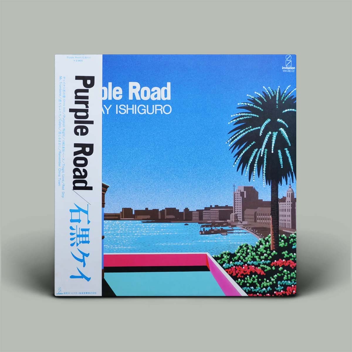 A square vinyl record sleeve for 'Purple Road', featuring a colorful illustration of a waterfront city scene with a palm tree, blue sky, water, and buildings, shown standing against a plain gray background.