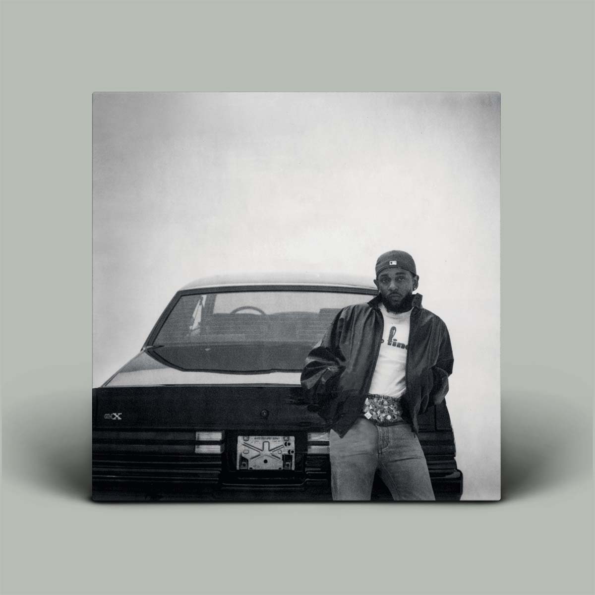 Person standing next to a car with a gray background